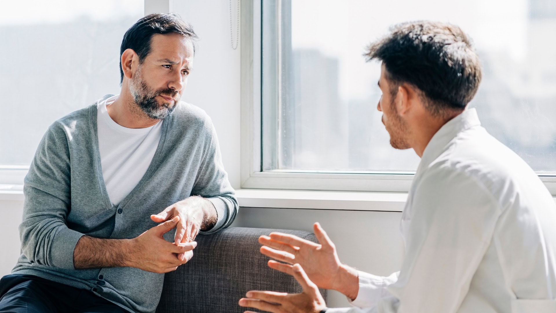 Professional counseling session for addiction and mental health treatment in Lakewood, CO, showing a supportive therapist and client in a comfortable office setting.